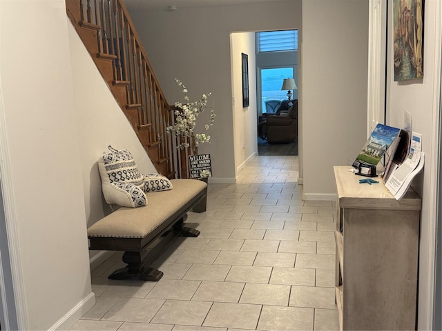19 Hillside Ave, Northport, NY 11768 - hall with baseboards, light tile patterned flooring, and stairway