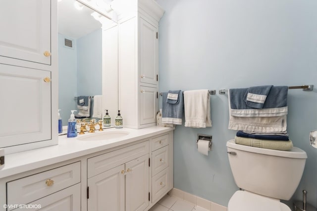 bathroom featuring tile patterned floors, vanity, visible vents, and toilet