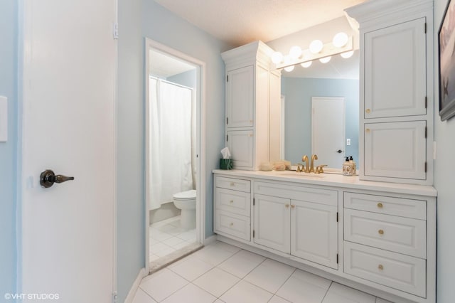 bathroom featuring vanity, a shower with curtain, tile patterned flooring, toilet, and baseboards