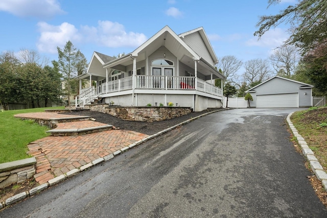 45 Nichols Rd, Huntington Station, NY 11746 - view of front of property with fence, a garage, a front lawn, an outbuilding, and a porch