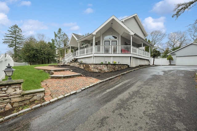 45 Nichols Rd, Huntington Station, NY 11746 - view of front of house with a porch, an outdoor structure, a front yard, and fence