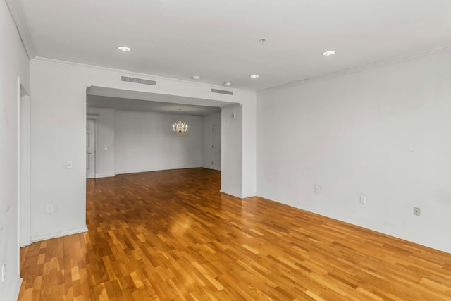 100 Harbor View Dr Unit 249, Port Washington, NY 11050 - spare room featuring visible vents, ornamental molding, wood finished floors, and a notable chandelier