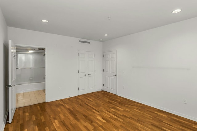 100 Harbor View Dr Unit 249, Port Washington, NY 11050 - unfurnished bedroom with baseboards, wood finished floors, and visible vents