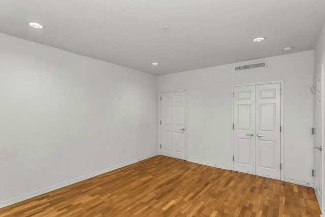 100 Harbor View Dr Unit 249, Port Washington, NY 11050 - unfurnished bedroom with visible vents, recessed lighting, and wood finished floors