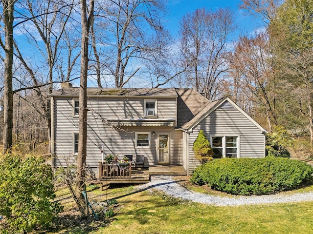 65 Hickory Ln, Bedford, NY 10506 - rear view of house with a lawn, a wooden deck, and a chimney