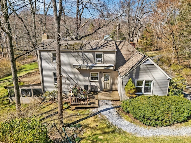 65 Hickory Ln, Bedford, NY 10506 - back of house with a chimney and a wooden deck