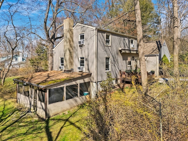 65 Hickory Ln, Bedford, NY 10506 - view of side of property with a chimney, a sunroom, a deck, and cooling unit