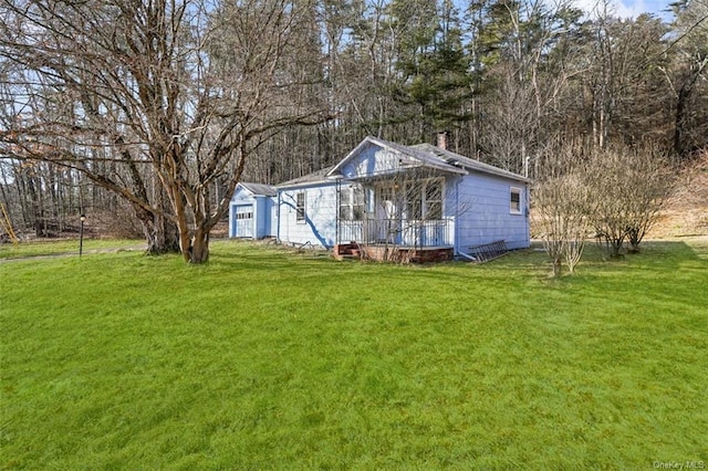 rear view of house featuring a lawn and a chimney