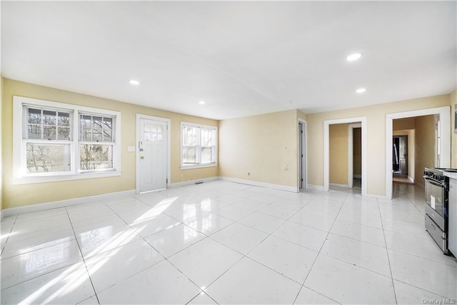 unfurnished living room with baseboards, recessed lighting, and light tile patterned floors