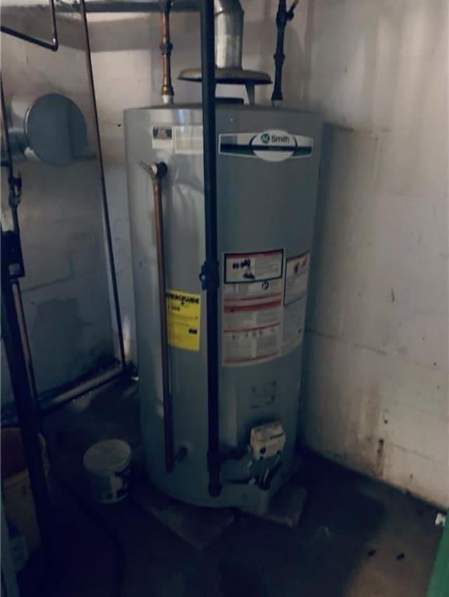 utility room featuring gas water heater