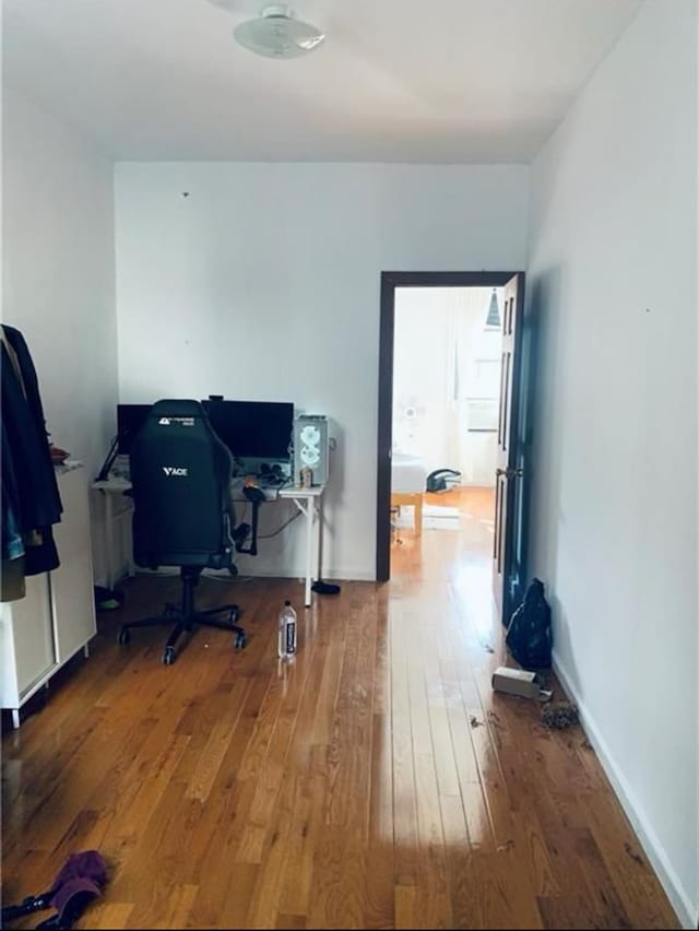 office space featuring baseboards and wood-type flooring