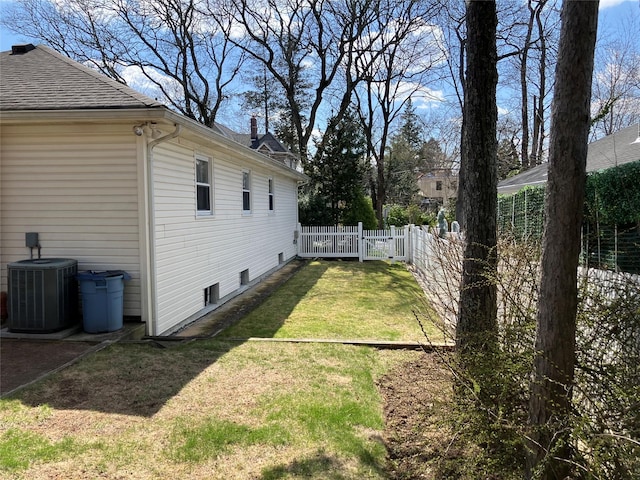 view of yard featuring central air condition unit and fence