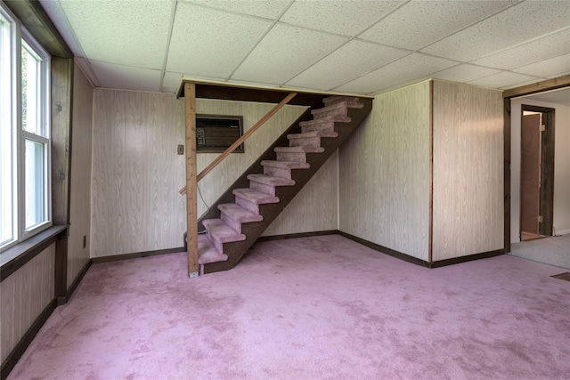 126-128 Christian Hill Rd, Dover Plains, NY 12522 - below grade area with a paneled ceiling, carpet flooring, stairway, wood walls, and a wall unit AC
