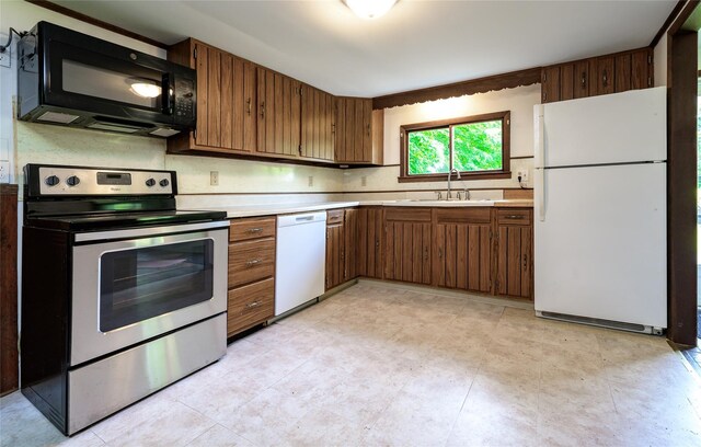126-128 Christian Hill Rd, Dover Plains, NY 12522 - kitchen with white appliances, light countertops, and brown cabinetry