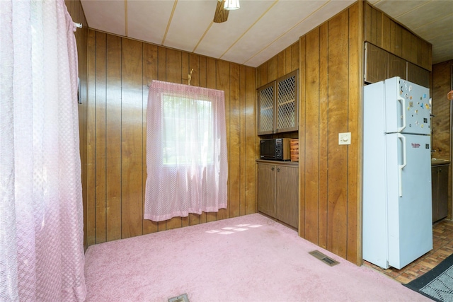126-128 Christian Hill Rd, Dover Plains, NY 12522 - kitchen featuring freestanding refrigerator, wooden walls, and carpet