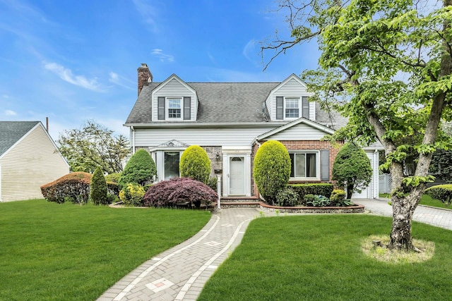 319 Maryland Ave, Freeport, NY 11520 - cape cod-style house featuring a chimney, a front lawn, a shingled roof, and brick siding