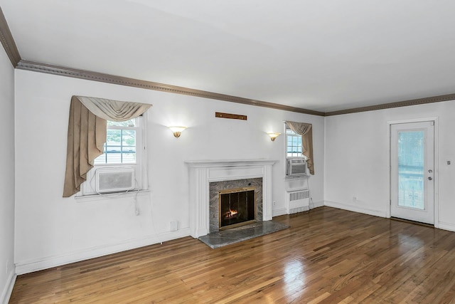 319 Maryland Ave, Freeport, NY 11520 - unfurnished living room featuring radiator, wood finished floors, ornamental molding, a fireplace, and cooling unit