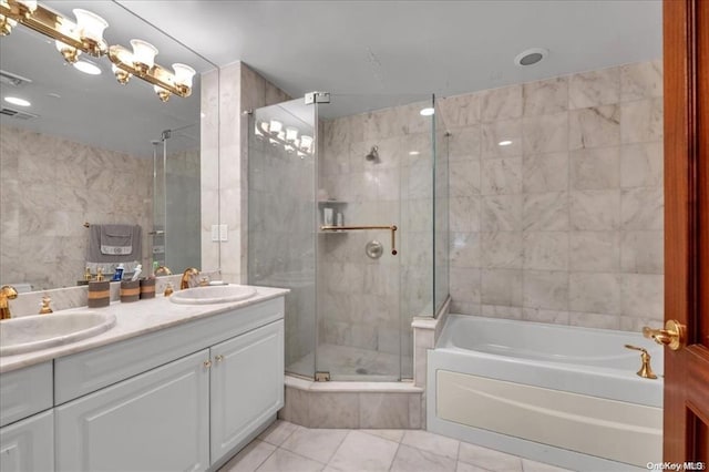 full bathroom featuring a shower stall, tile walls, a sink, and a garden tub