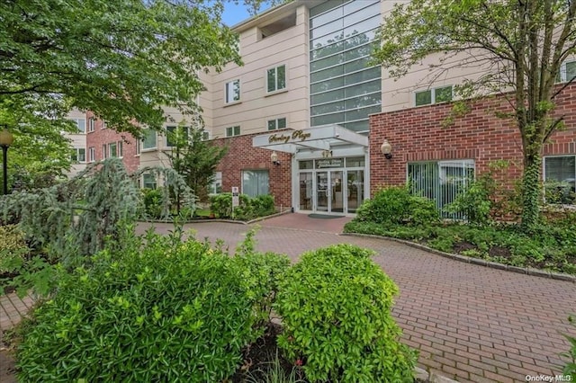 exterior space featuring french doors and brick siding