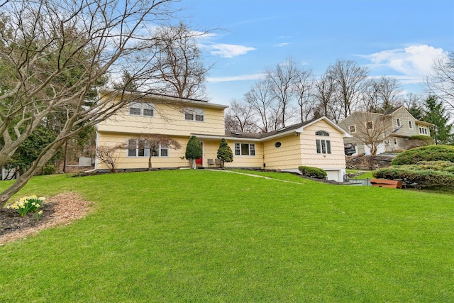 view of front facade with a front yard and an attached garage