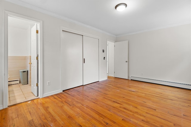 unfurnished bedroom featuring ornamental molding, light wood finished floors, and a baseboard radiator