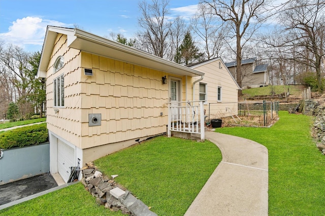 view of side of property with a lawn