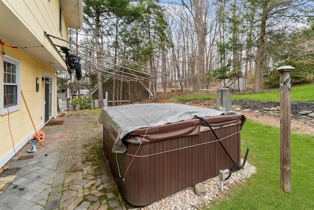 view of yard featuring fence, a hot tub, and a patio area