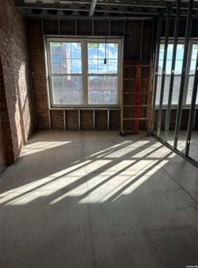 miscellaneous room with brick wall