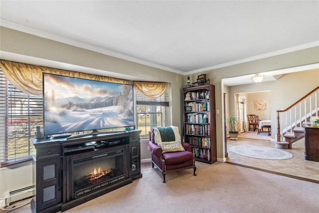 sitting room featuring carpet flooring, ornamental molding, a glass covered fireplace, and stairs