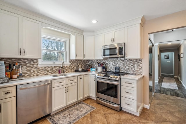 kitchen featuring backsplash, light countertops, a sink, and stainless steel appliances