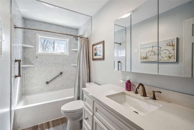 full bath with shower / tub combo, wood finished floors, toilet, and vanity