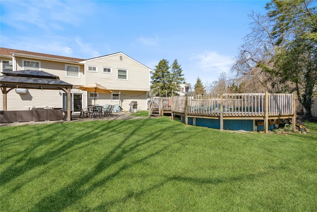 view of yard featuring a patio, a gazebo, and a deck