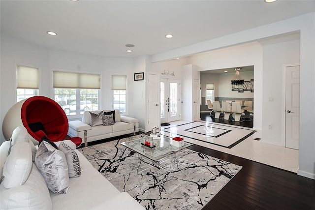 living room featuring recessed lighting, baseboards, and hardwood / wood-style flooring