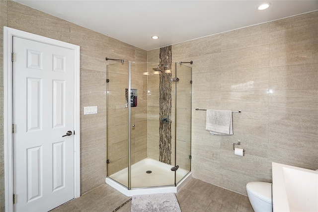 full bathroom featuring a shower stall, toilet, recessed lighting, and tile patterned flooring