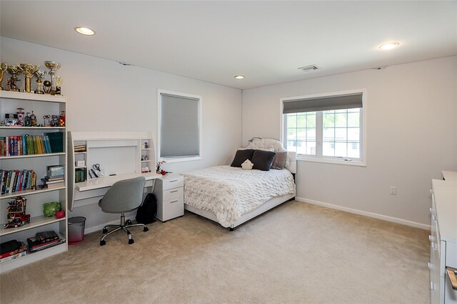 bedroom featuring light colored carpet, recessed lighting, a desk, and baseboards