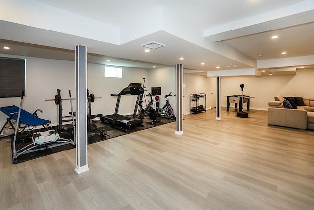 workout room featuring light wood-type flooring, baseboards, and recessed lighting