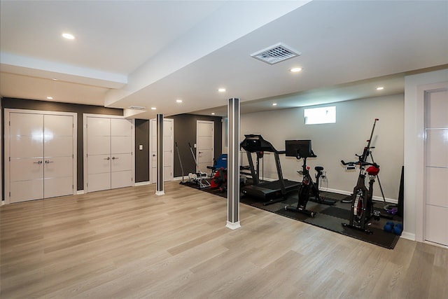 exercise room featuring light wood-type flooring, baseboards, and recessed lighting