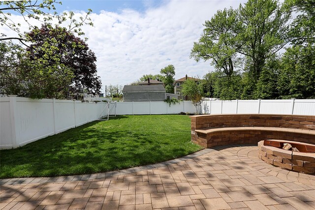 view of yard with an outdoor fire pit and a patio