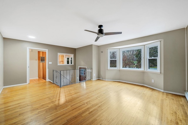 spare room featuring wood finished floors, ceiling fan, baseboards, and recessed lighting