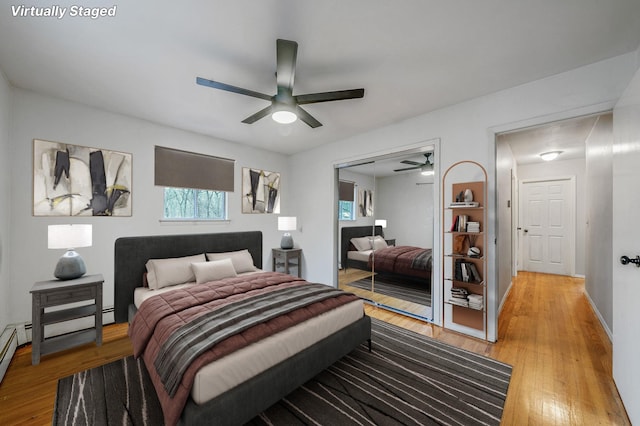 bedroom with a closet, light wood-type flooring, and ceiling fan