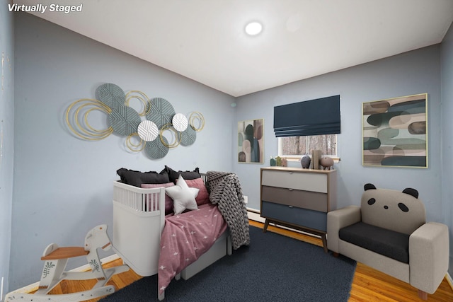 bedroom with baseboards and wood finished floors