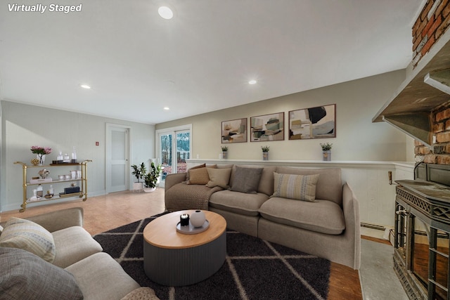 living room featuring a baseboard radiator, wood finished floors, and recessed lighting