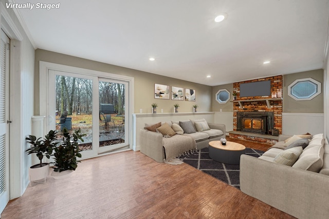 living area with recessed lighting, wood finished floors, and a fireplace