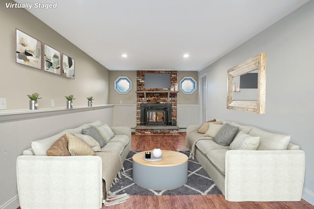 living area featuring wood finished floors, a fireplace, and recessed lighting