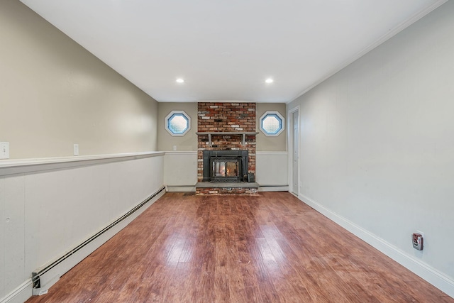 unfurnished living room featuring baseboards, a baseboard radiator, a fireplace, recessed lighting, and wood finished floors