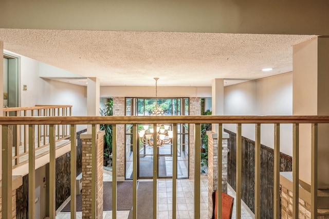 687 Bronx River Rd # 2A, Yonkers, NY 10704 - corridor with a textured ceiling and a chandelier