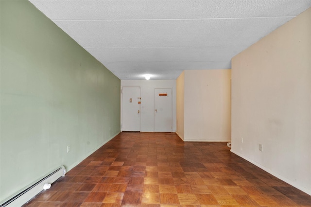 687 Bronx River Rd # 2A, Yonkers, NY 10704 - spare room featuring baseboard heating and a textured ceiling