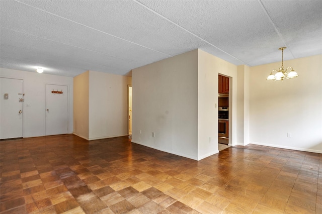 687 Bronx River Rd # 2A, Yonkers, NY 10704 - spare room featuring a chandelier and a textured ceiling
