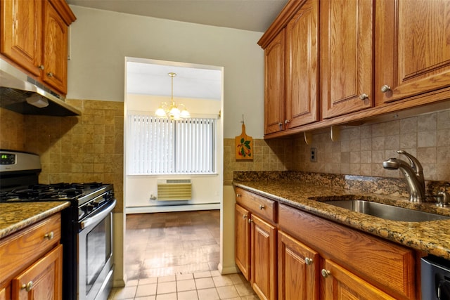 687 Bronx River Rd # 2A, Yonkers, NY 10704 - kitchen with gas range, under cabinet range hood, a baseboard radiator, brown cabinetry, and dark stone counters
