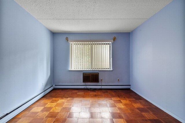 687 Bronx River Rd # 2A, Yonkers, NY 10704 - spare room with a baseboard heating unit, a textured ceiling, and an AC wall unit